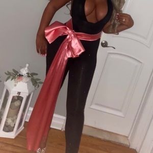 back  jumpsuit covered in black sequins with pink bow